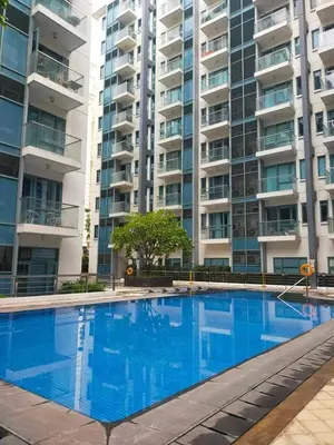 a large swimming pool in front of a large apartment building at Nadzcondotel - at Two Palm Tree Villas o in Manila