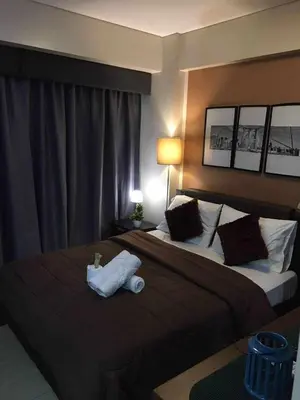 a hotel room with two beds with towels on them at Infinity Stay in Manila