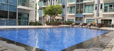 a large swimming pool in front of a building at Infinity Stay in Manila