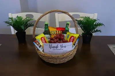 a basket of snacks and drinks on a table at Spacious and Cozy 2 Br in The Gramercy Poblacion in Manila