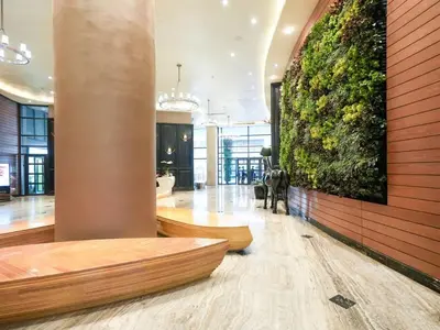 a lobby with a large plant on the wall at High Floor 2BR in Knightsbridge Residences Makati in Manila