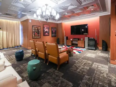 a living room with chairs and a flat screen tv at High Floor 2BR in Knightsbridge Residences Makati in Manila
