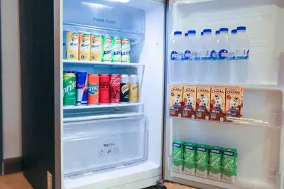 an open refrigerator filled with drinks and drinks at High Floor 2BR in Knightsbridge Residences Makati in Manila