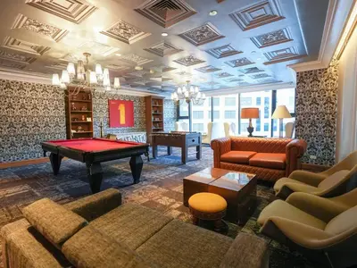 a living room with couches and a pool table at High Floor 2BR in Knightsbridge Residences Makati in Manila