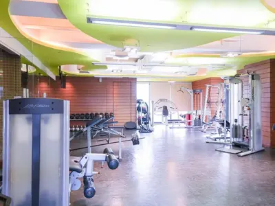 a gym with dumbbells and weights in a room at High Floor 2BR in Knightsbridge Residences Makati in Manila