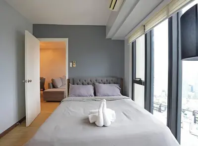 a white stuffed animal sitting on top of a bed at High Floor 2BR in Knightsbridge Residences Makati in Manila