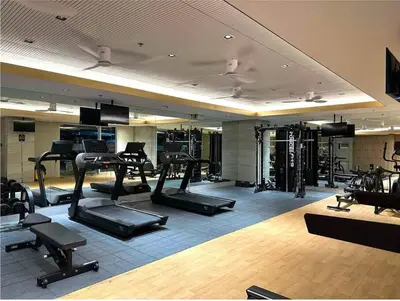 a gym with several treadmills and exercise bikes at Cozy 2BR Unit in FAME Residences, Mandaluyong City in Manila