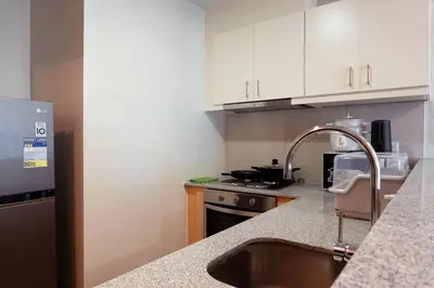 a kitchen with a sink and a counter top at Parksuites BGC - Spacious 2 Bedroom in Manila