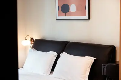a black couch with two white pillows in a room at Parksuites BGC - Spacious 2 Bedroom in Manila