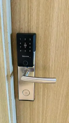a metal door handle on a wooden door at Homey Staycation at MOA Complex in Manila