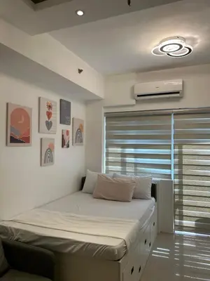a bed in a room with a window and a bedvisor at Casa Zahra in Manila