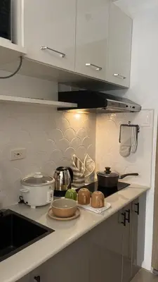 a kitchen counter with some pots and pans on it at Casa Zahra in Manila