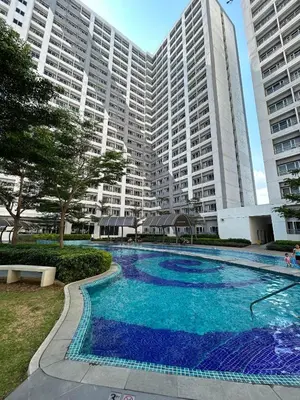 a swimming pool in front of a large building at Casa Zahra in Manila