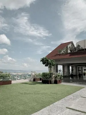 a view of a building with a green lawn at 2BR The Blums at Prisma Residences in Manila