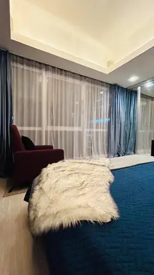 a living room with a bed with a furry rug at BEAUTIFUL and SPACIOUS 2 REAL BEDROOMS 2 BATHROOMS IN BGC GLOBAL CITY in Manila