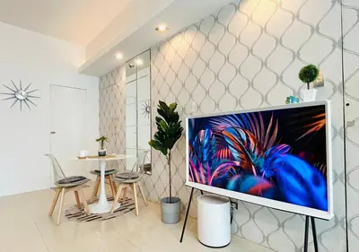 a living room with a flat screen tv on a stand at BEAUTIFUL and SPACIOUS 2 REAL BEDROOMS 2 BATHROOMS IN BGC GLOBAL CITY in Manila