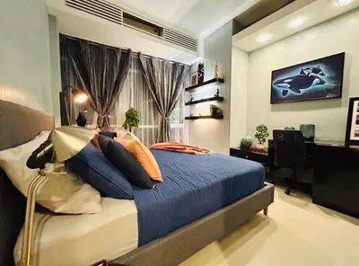 a bedroom with a bed and a desk and a computer at BEAUTIFUL and SPACIOUS 2 REAL BEDROOMS 2 BATHROOMS IN BGC GLOBAL CITY in Manila