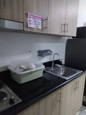 a kitchen counter top with a sink and a sink at Shore 2 Family Suite 2 Beds Balcony City View WiFi Netflix MOA 735 in Manila