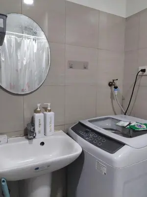 a bathroom with a sink and a toilet and a mirror at Shore 2 Family Suite 2 Beds Balcony City View WiFi Netflix MOA 735 in Manila