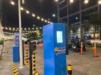 a parking meter in a parking lot at night at Shore 2 Family Suite 2 Beds Balcony City View WiFi Netflix MOA 735 in Manila