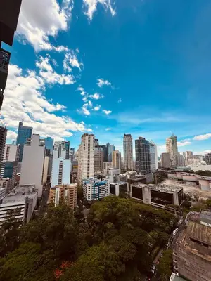 a view of a city skyline with tall buildings at Newly Renovated 2-storey Loft at Greenbelt 1 in Manila