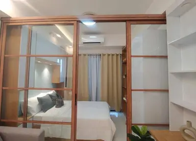 a room with a bed and a glass wall at Happy Haven at Lush Makati in Manila