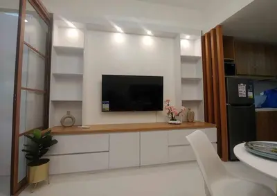 a living room with a flat screen tv on a wall at Happy Haven at Lush Makati in Manila