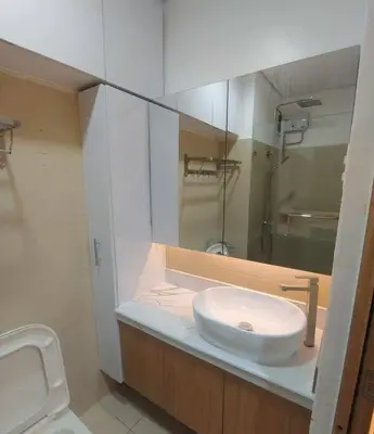 a bathroom with a sink and a toilet at Happy Haven at Lush Makati in Manila