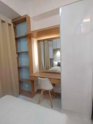 a bedroom with a desk and a bed and a mirror at Happy Haven at Lush Makati in Manila