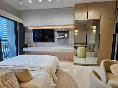 a bedroom with a large bed and a kitchen at Alexa Smart Home l Balcony Night View l Fast Wifi in Manila