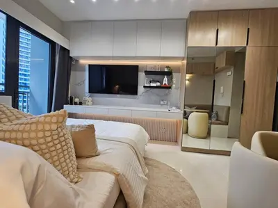 a bedroom with a bed and a living room with a tv at Alexa Smart Home l Balcony Night View l Fast Wifi in Manila