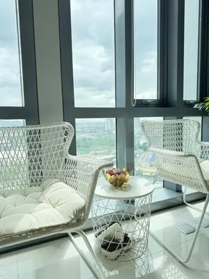 two chairs and a table in a room with windows at Eastwood Global Plaza Luxury 1Bed Room with 2 Toilets and Laundry Room in Manila