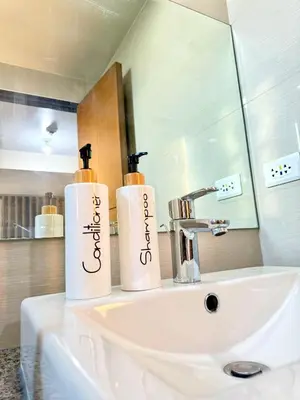 two towels sitting on top of a bathroom sink at Eastwood Global Plaza Luxury 1Bed Room with 2 Toilets and Laundry Room in Manila