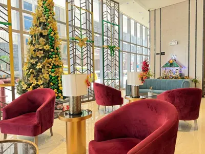 a christmas tree in a lobby with red chairs at Eastwood Global Plaza Luxury 1Bed Room with 2 Toilets and Laundry Room in Manila