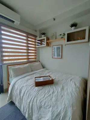 a bedroom with a bed with a tray on it at Casa Florentino in Manila