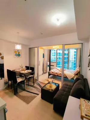 a living room with a couch and a dining room at CHILL City Escapes at Azure Urban Residences in Manila