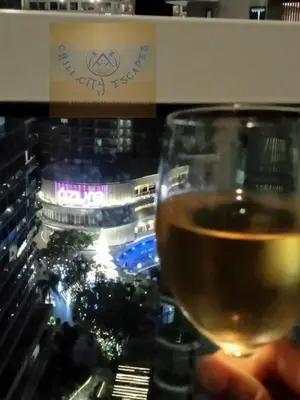 a person holding a glass of wine at CHILL City Escapes at Azure Urban Residences in Manila