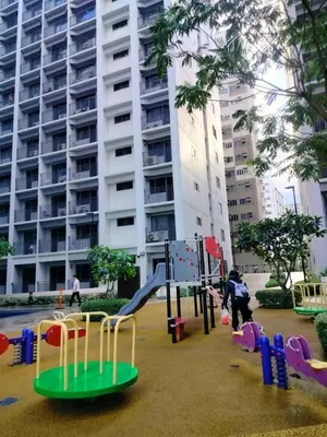 a playground in front of a large apartment building at SMDC StayWise Space in Manila