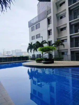 a swimming pool in front of a building at SMDC StayWise Space in Manila