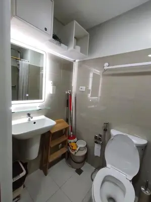 a small bathroom with a toilet and a sink at Casa Florentino in Manila