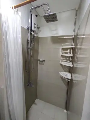 a bathroom with a shower with a shower curtain at Casa Florentino in Manila