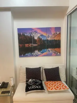 a living room with a couch and a painting on the wall at Azure Urban Residences Bahamas & One bedroom in Manila