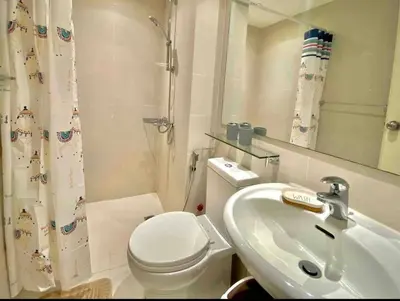 a bathroom with a white toilet and a sink at Azure Urban Residences Bahamas & One bedroom in Manila