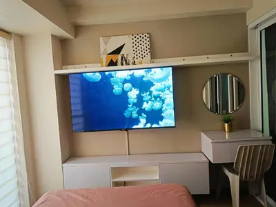 a room with a flat screen tv on a wall at Condominium in Manila