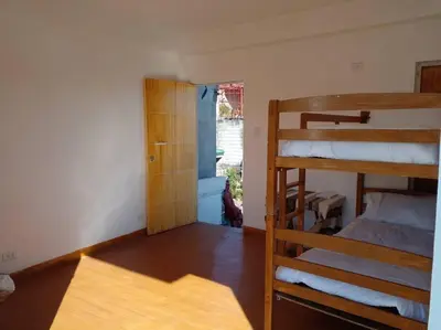 a room with two bunk beds and a window at Taguig Apartment Near ARCA South in Manila
