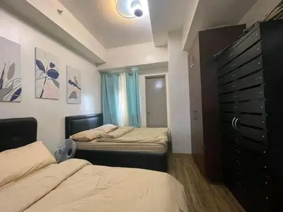 a small bedroom with two beds and a dresser at One taft residence taft avenue City Land manila in Manila