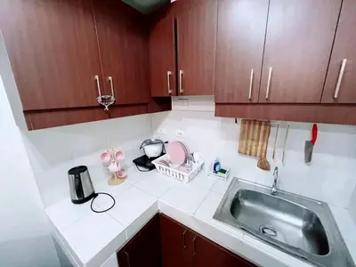 a kitchen with a sink and a counter top at One taft residence taft avenue City Land manila in Manila