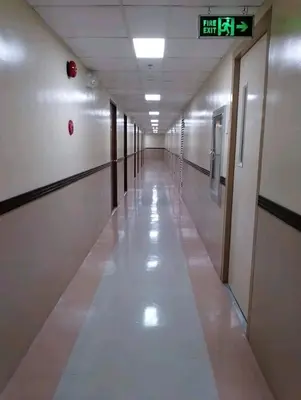an empty hallway in a building with a sign on the wall at One taft residence taft avenue City Land manila in Manila