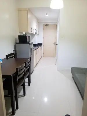 a small kitchen with a table and chairs in a room at Sea residence Family Group Affordable staycation in Manila