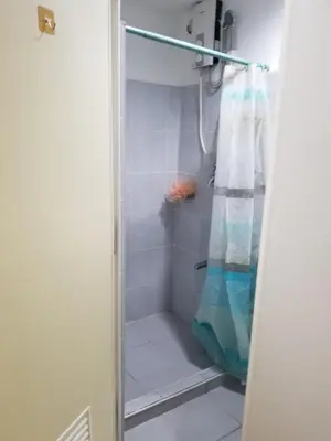 a shower with a shower curtain in a bathroom at Sea residence Family Group Affordable staycation in Manila